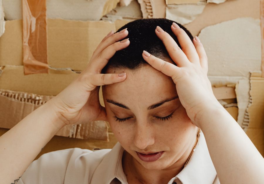 stressed woman with her head in her hands